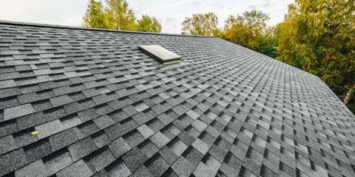 roof of new house with shingles roof-tiles and ventilation window